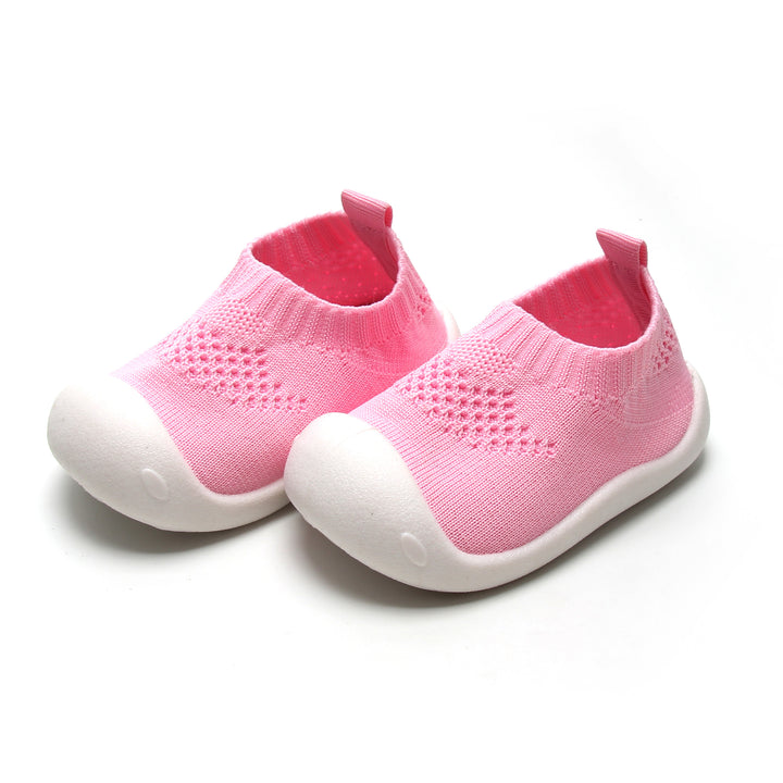 Pink slip-on shoes for kids with flexible design, ideal for natural foot development.