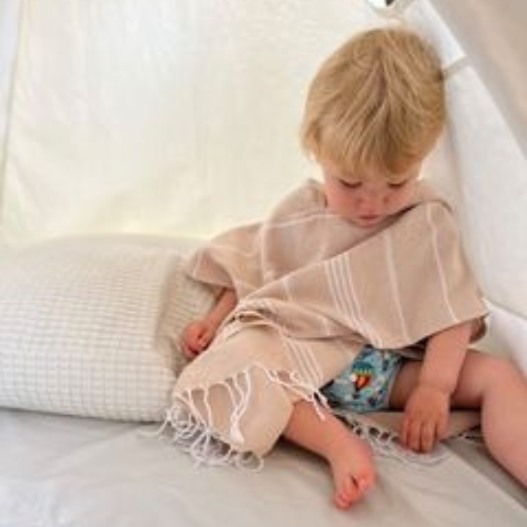 Charming hooded poncho towel for kids, featuring vibrant colours that brighten up any beach or pool setting.