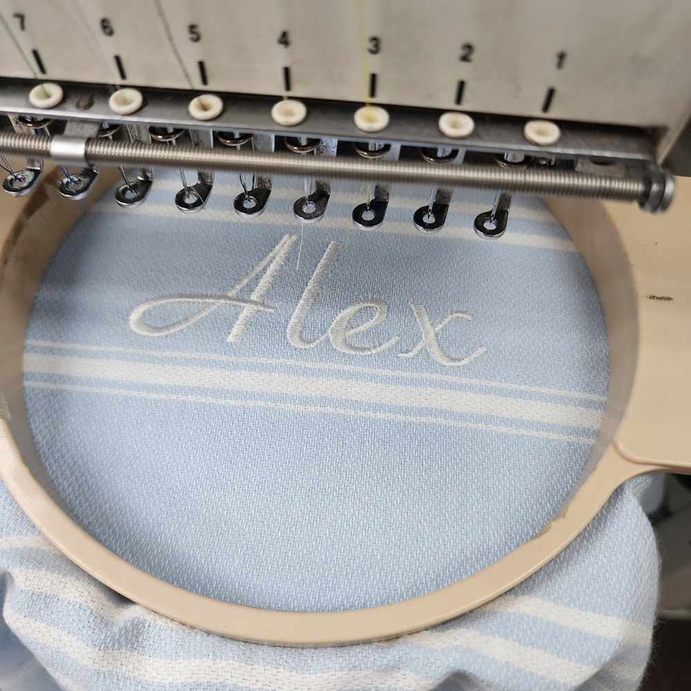 Personalised kids poncho towel featuring a child’s name in elegant script, ideal for making a unique gift.
